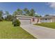 Gray house with red shutters, two-car garage, and a driveway at 319 St Cloud Rd, Poinciana, FL 34759