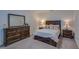 Bedroom with a queen bed, dresser, and nightstands at 319 St Cloud Rd, Poinciana, FL 34759