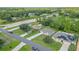 Aerial view of houses on a tree-lined street, one with solar panels at 319 St Cloud Rd, Poinciana, FL 34759