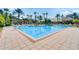 Resort-style pool with spacious deck and palm trees at 8362 Bella Tierra Ct, Davenport, FL 33896