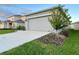 One-story house with a two-car garage at 1393 Asher Mason Ave, Kissimmee, FL 34744