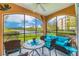 Relaxing screened lanai overlooking a lake, featuring comfortable seating and a table at 8815 Worldquest Blvd # 103 In Building 3, Orlando, FL 32821
