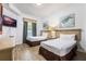 Two twin beds, a TV, and calming artwork in a well-lit bedroom at 8815 Worldquest Blvd # 103 In Building 3, Orlando, FL 32821