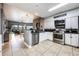 Well-equipped kitchen with white cabinets and stainless steel appliances at 8815 Worldquest Blvd # 103 In Building 3, Orlando, FL 32821