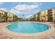 Relaxing community pool with surrounding lounge chairs and building views at 8815 Worldquest Blvd # 103 In Building 3, Orlando, FL 32821