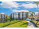 Attractive building exterior with a walkway by the lake at 8815 Worldquest Blvd # 103 In Building 3, Orlando, FL 32821