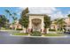 Grand entrance to the community with landscaping and a golf cart at 8815 Worldquest Blvd # 103 In Building 3, Orlando, FL 32821