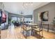 Open concept dining area with glass table and chairs, adjacent to living room at 8815 Worldquest Blvd # 103 In Building 3, Orlando, FL 32821