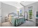 Charming bedroom with a metal bed frame and private balcony access at 593 Lake Wildmere Cv, Longwood, FL 32750