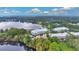Aerial view showcasing townhomes and lakefront property at 593 Lake Wildmere Cv, Longwood, FL 32750