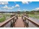 Wooden deck overlooking a serene lake with lily pads at 593 Lake Wildmere Cv, Longwood, FL 32750
