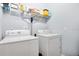 Convenient laundry room complete with washer, dryer, and shelving at 593 Lake Wildmere Cv, Longwood, FL 32750