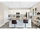 Modern kitchen with white cabinets, a large island, and stainless steel appliances at 593 Lake Wildmere Cv, Longwood, FL 32750