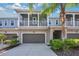 Two-story townhome with balcony, double garage and landscaping at 593 Lake Wildmere Cv, Longwood, FL 32750