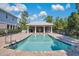 Community pool with a covered patio and brick pavers at 593 Lake Wildmere Cv, Longwood, FL 32750
