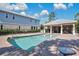 Community pool with a covered patio and brick pavers at 593 Lake Wildmere Cv, Longwood, FL 32750