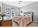Comfortable bedroom with ceiling fan and private balcony at 593 Lake Wildmere Cv, Longwood, FL 32750