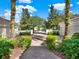 Attractive community entry with lush landscaping and brick-paved walkways at 10323 Kensington Shore Dr # 201, Orlando, FL 32827