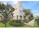 Three-story townhouse with gray siding and landscaping at 594 Piazza Pt, Oviedo, FL 32765