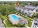 Aerial view of townhouses with pool and landscaping at 594 Piazza Pt, Oviedo, FL 32765