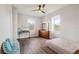 Bedroom with wood flooring, ceiling fan, and views of nature at 594 Piazza Pt, Oviedo, FL 32765