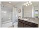 Bathroom with shower/tub combo, granite vanity, and dark brown cabinets at 594 Piazza Pt, Oviedo, FL 32765