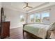 Bright bedroom with wood flooring, large windows, and a ceiling fan at 594 Piazza Pt, Oviedo, FL 32765