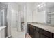 Bathroom featuring granite countertop, dark brown vanity, and shower at 594 Piazza Pt, Oviedo, FL 32765