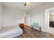 Bedroom with wood flooring, ceiling fan, and access to bathroom at 594 Piazza Pt, Oviedo, FL 32765