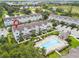 Aerial view of townhouses, pool, and community at 594 Piazza Pt, Oviedo, FL 32765