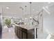 Open kitchen with large island, overlooking living room and stairs at 594 Piazza Pt, Oviedo, FL 32765
