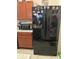 Black French door refrigerator in a well-lit kitchen at 4644 Glencrest Loop, Saint Cloud, FL 34772