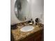 Vanity with granite countertop and oval mirror at 4743 S Texas Ave # 4743B, Orlando, FL 32839