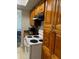Kitchen with wood cabinets, granite counters, and appliances at 4743 S Texas Ave # 4743B, Orlando, FL 32839