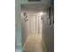 Hallway with neutral walls and tile flooring leading to laundry area at 4743 S Texas Ave # 4743B, Orlando, FL 32839