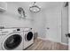 Bright laundry room, features washer, dryer, and ample shelving at 1008 Overlook Ct, Davenport, FL 33837