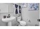 Clean bathroom with pedestal sink, toilet, and modern decor at 1008 Overlook Ct, Davenport, FL 33837