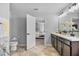 Double vanity bathroom with walk-in shower and view of bedroom at 1008 Overlook Ct, Davenport, FL 33837