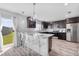 Modern kitchen with dark cabinetry, stainless steel appliances, and breakfast bar at 1008 Overlook Ct, Davenport, FL 33837