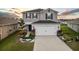 Two-story house with gray siding, white garage door, and landscaped yard at 1008 Overlook Ct, Davenport, FL 33837