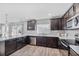 Well-equipped kitchen featuring dark cabinetry and stainless steel appliances at 1008 Overlook Ct, Davenport, FL 33837