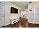 Upstairs hallway with TV and hardwood floors at 221 Las Fuentes Dr, Kissimmee, FL 34746