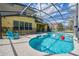 Inviting pool area with screened enclosure, patio furniture, and a spacious deck at 221 Las Fuentes Dr, Kissimmee, FL 34746