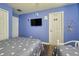 Guest bedroom with two twin beds and a TV at 221 Las Fuentes Dr, Kissimmee, FL 34746