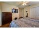 Spacious bedroom with wood floors, large TV, and ample closet space at 221 Las Fuentes Dr, Kissimmee, FL 34746