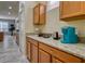Kitchen with light wood cabinets, granite countertops, and modern appliances at 221 Las Fuentes Dr, Kissimmee, FL 34746