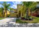 Two-story home with attached garage and lush landscaping at 221 Las Fuentes Dr, Kissimmee, FL 34746