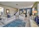 Open living room with hardwood floors, neutral colored sofas, and a view of the dining area at 221 Las Fuentes Dr, Kissimmee, FL 34746