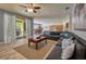 Spacious living room with sectional sofa and access to patio at 221 Las Fuentes Dr, Kissimmee, FL 34746