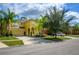 Community view showing homes with palm trees and driveway at 221 Las Fuentes Dr, Kissimmee, FL 34746